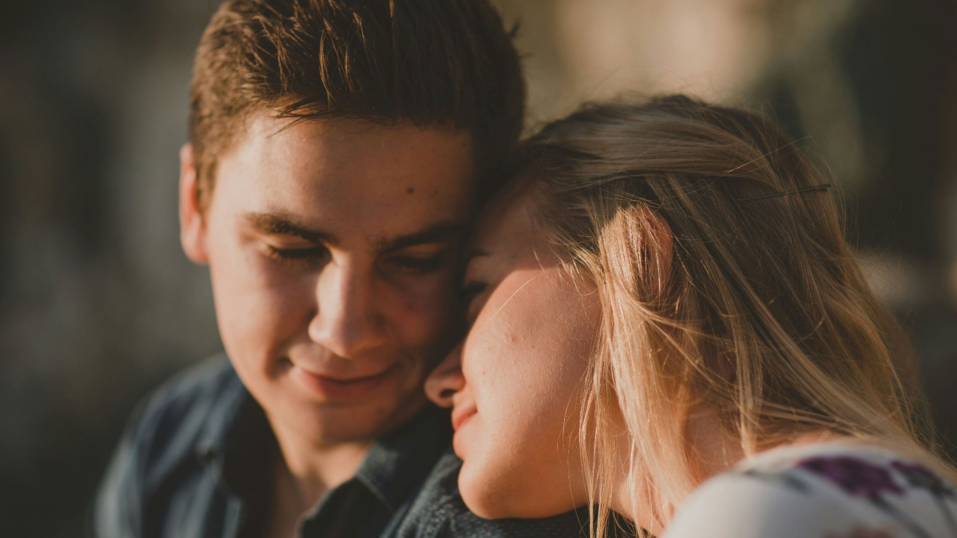 woman leaning on man's shoulder