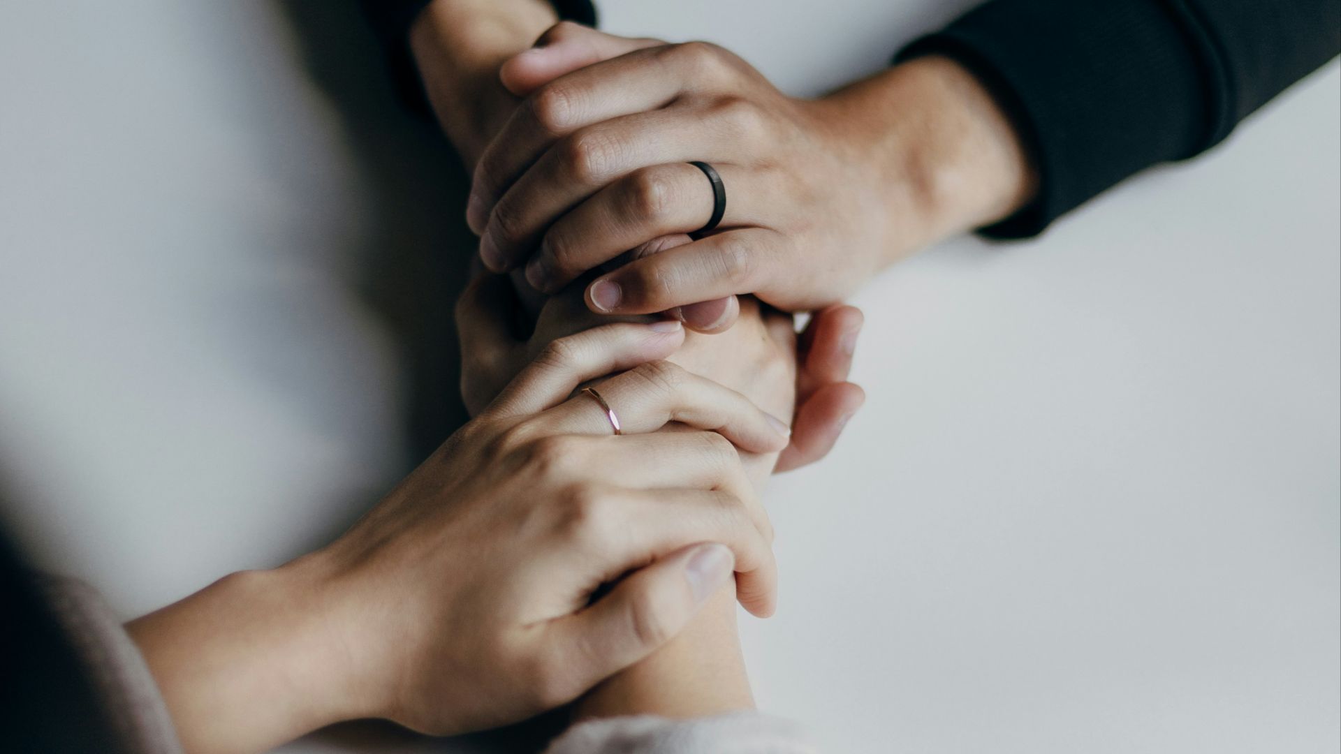 person in black long sleeve shirt holding babys feet