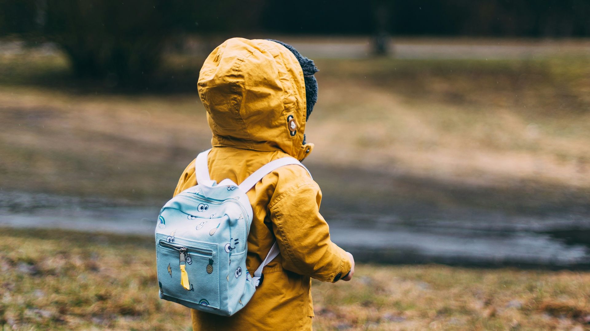 shallow focus photo of toddler walking near river