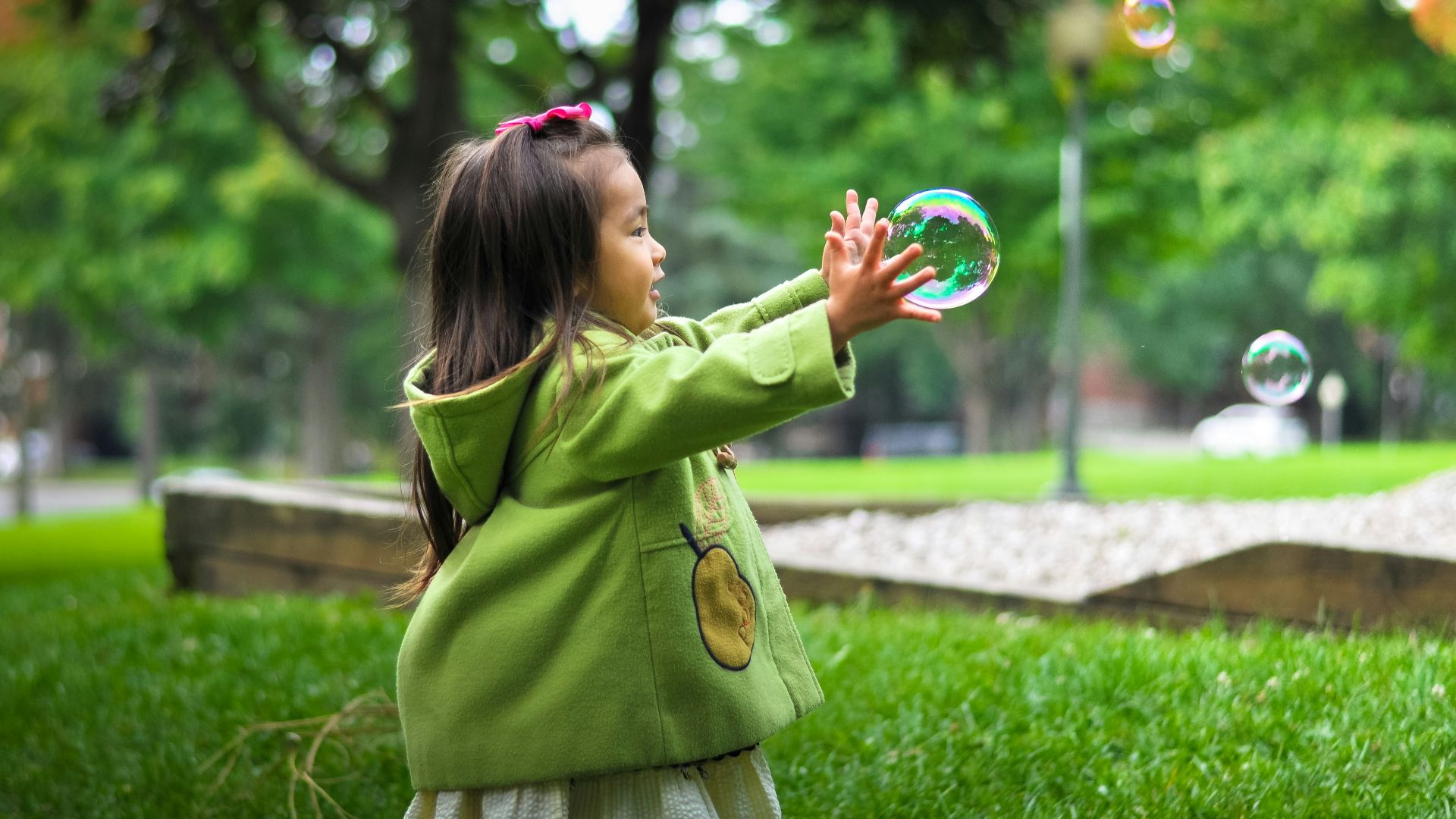 selective photo of a girl holding bubbles