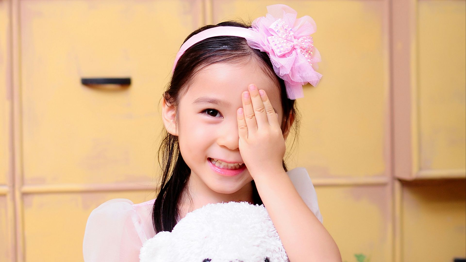 girl hugging brown bear plush toy