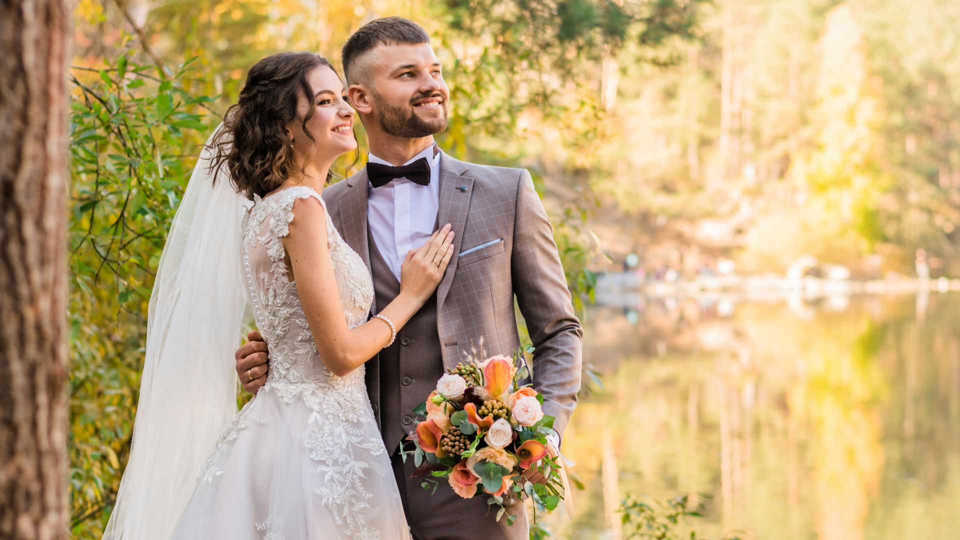 man in gray suit and woman in white wedding dress
