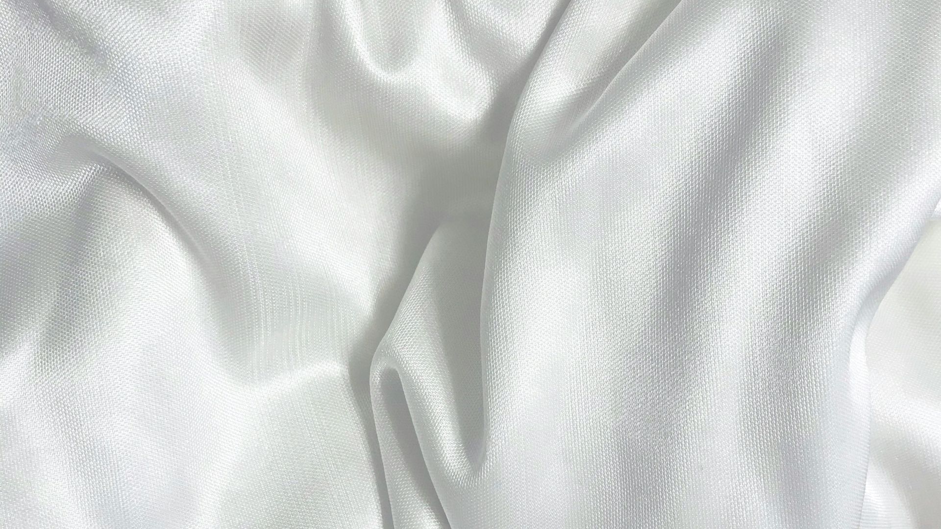 white textile on brown wooden table