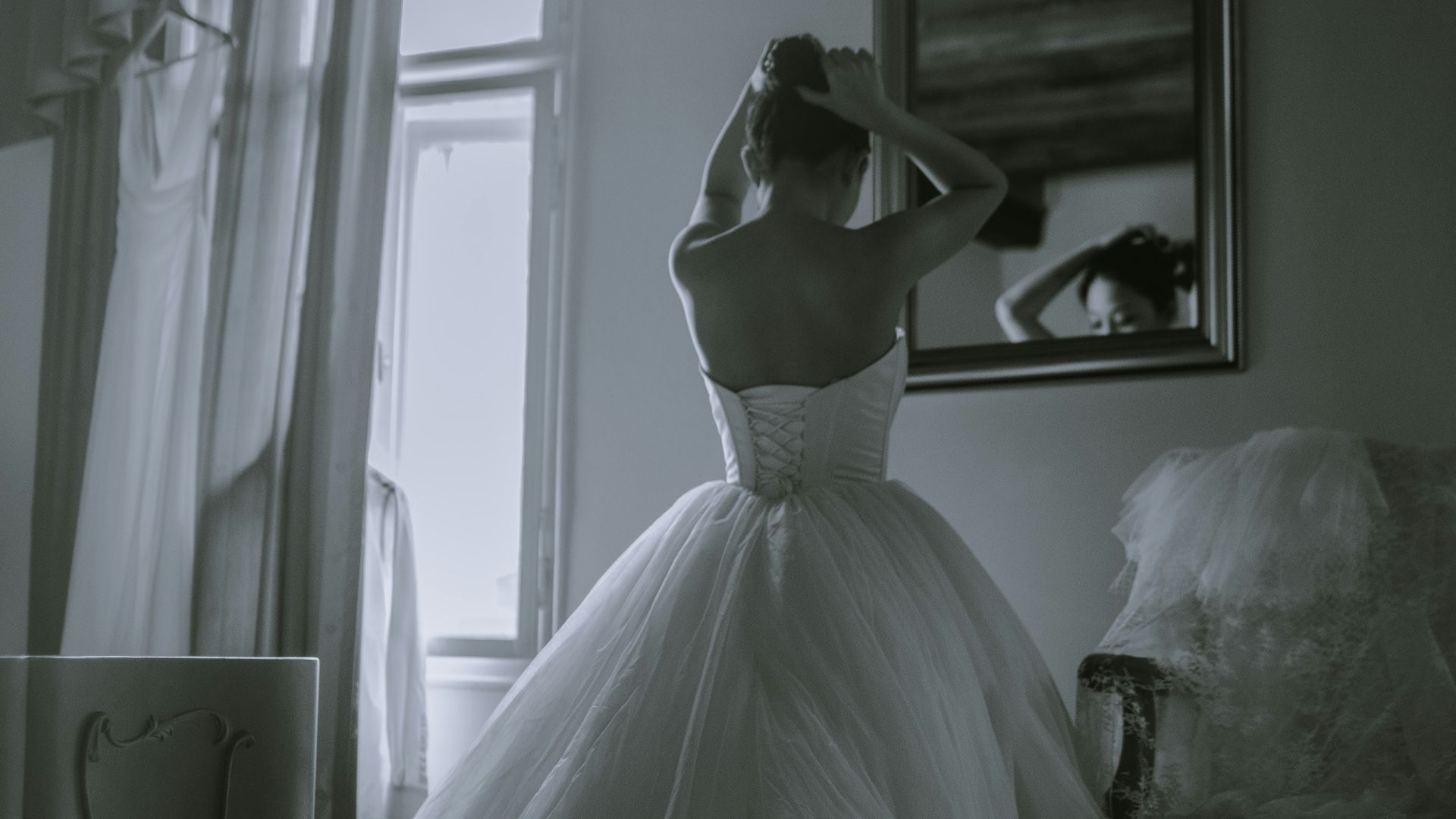 grayscale photo of woman facing on mirror