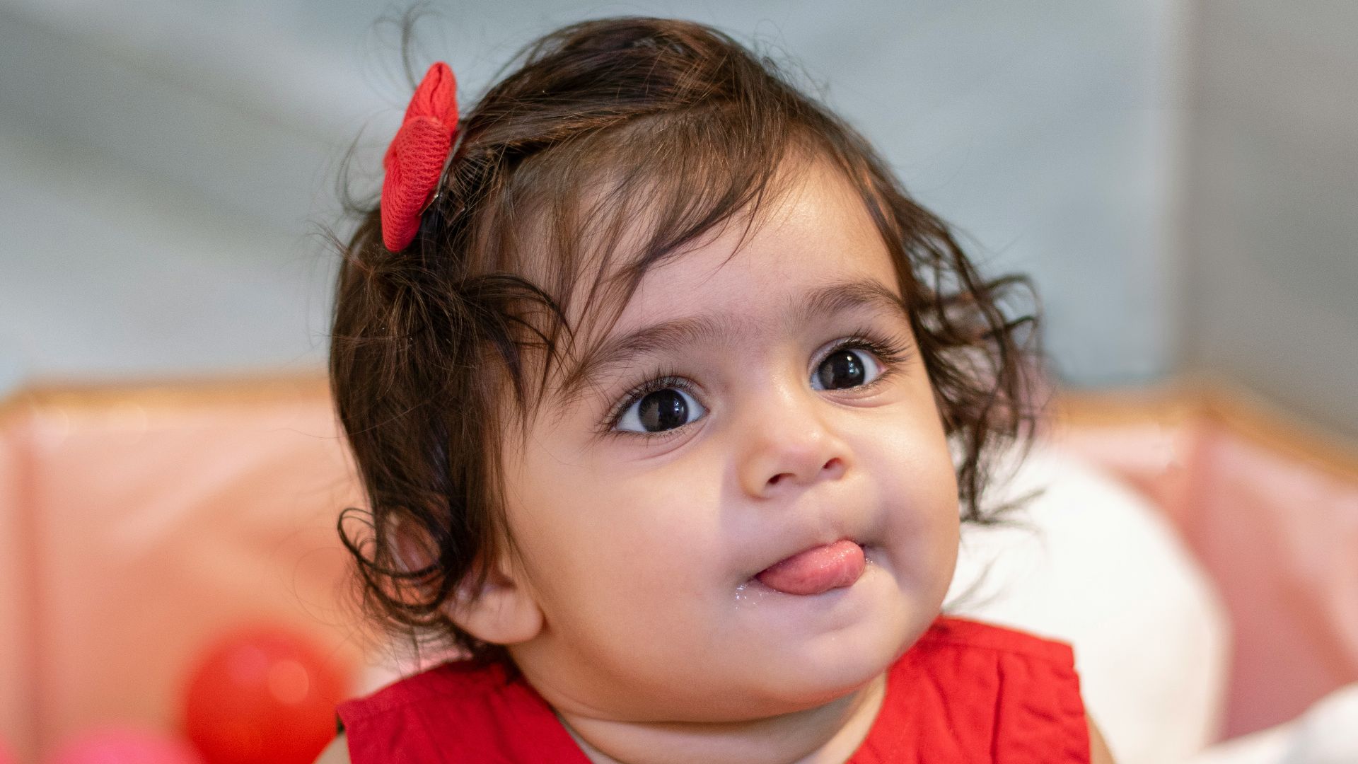 a little girl sitting in a ball pit