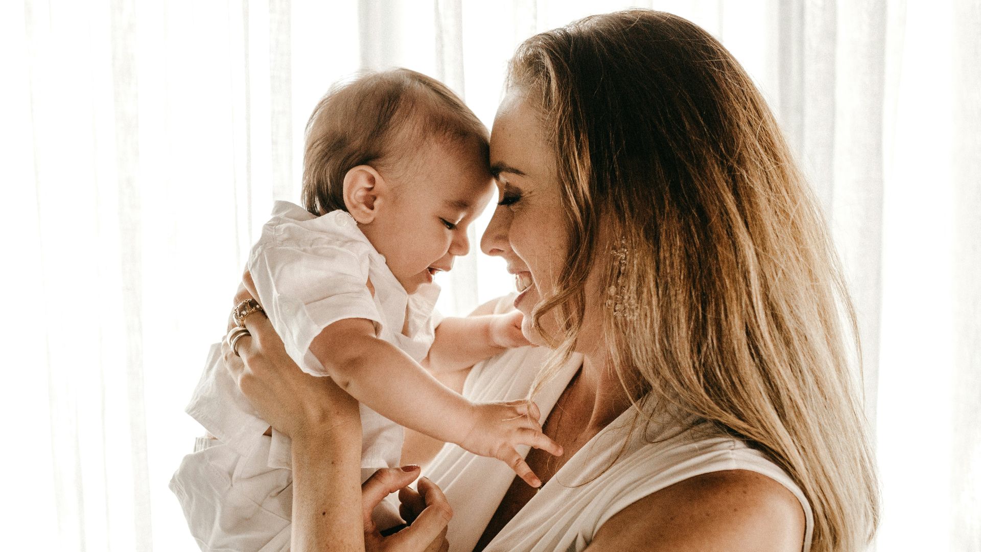 smiling woman carrying baby