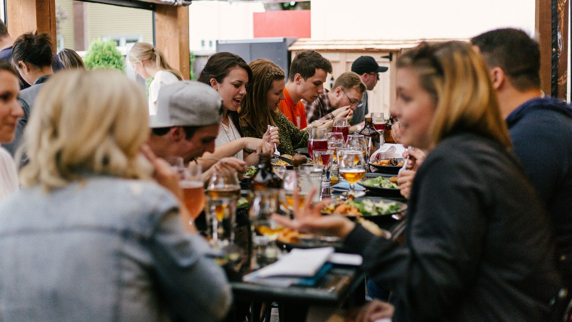 people sitting in front of table talking and eating