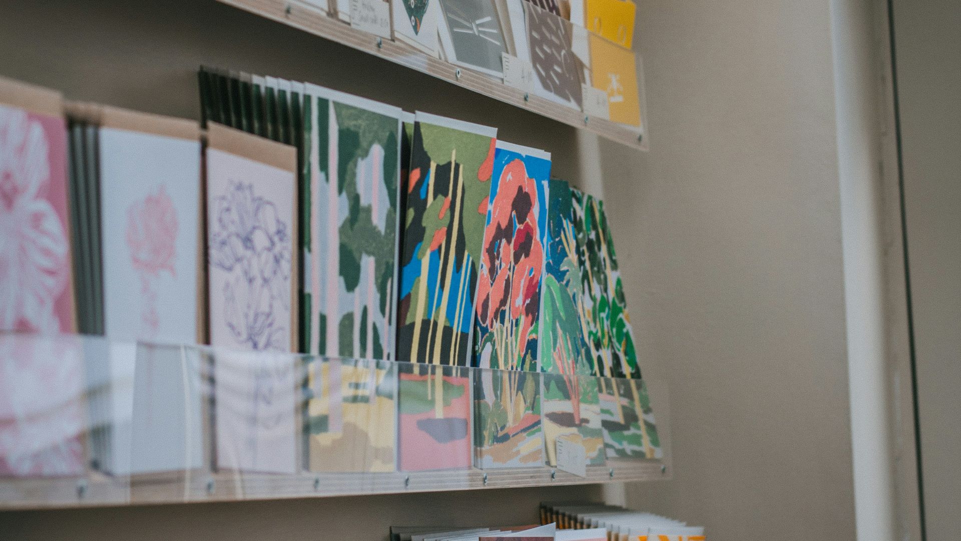 a bunch of cards on a shelf in a room