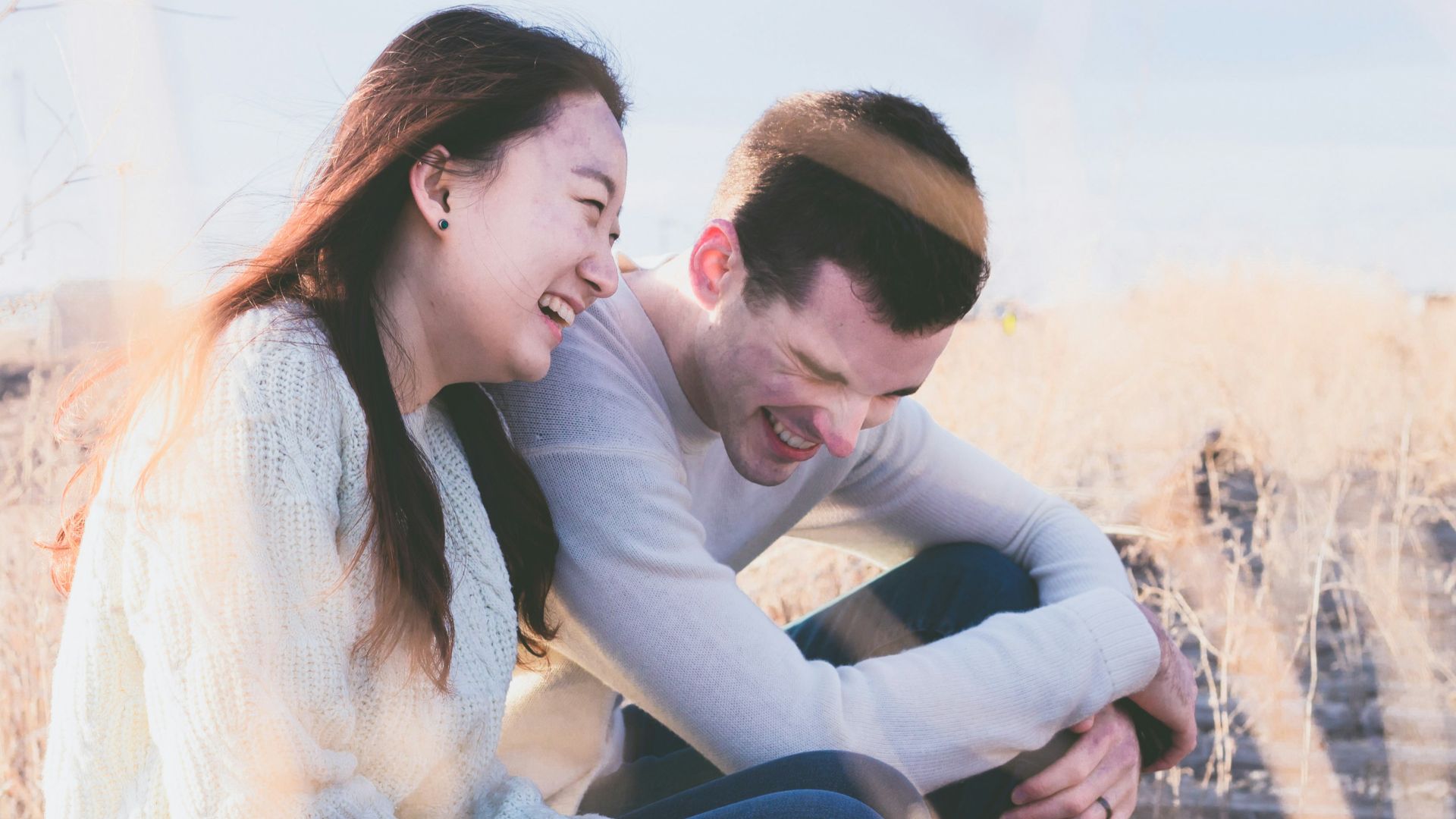 photo of man and woman laughing during daytime
