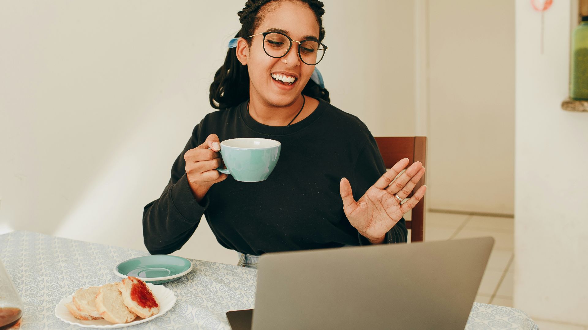 woman in black long sleeve shirt holding white ceramic mug