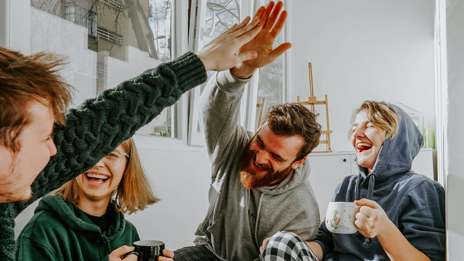 woman in black and white checkered long sleeve shirt sitting beside man in green crew neck