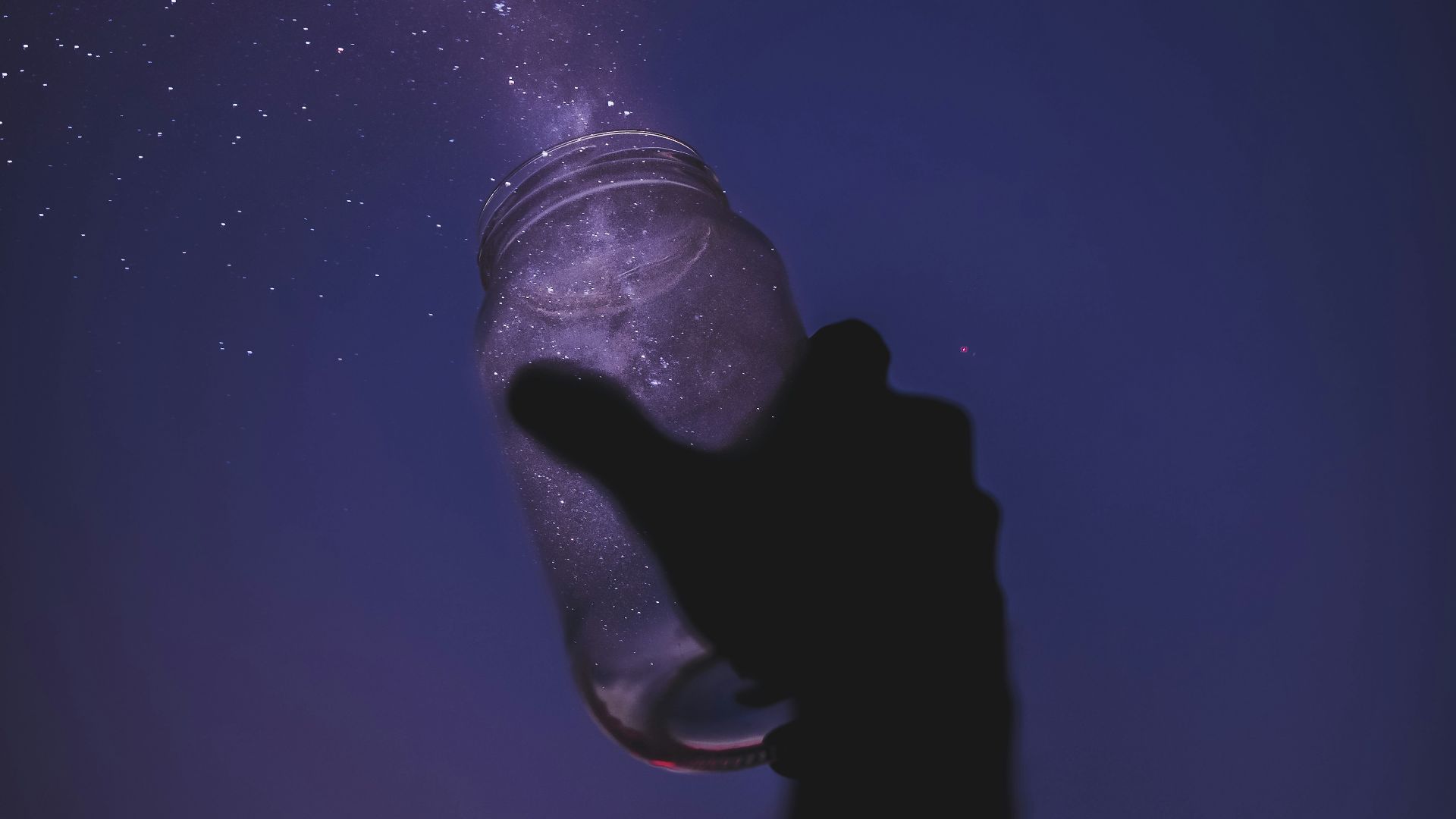 person holding glass jar