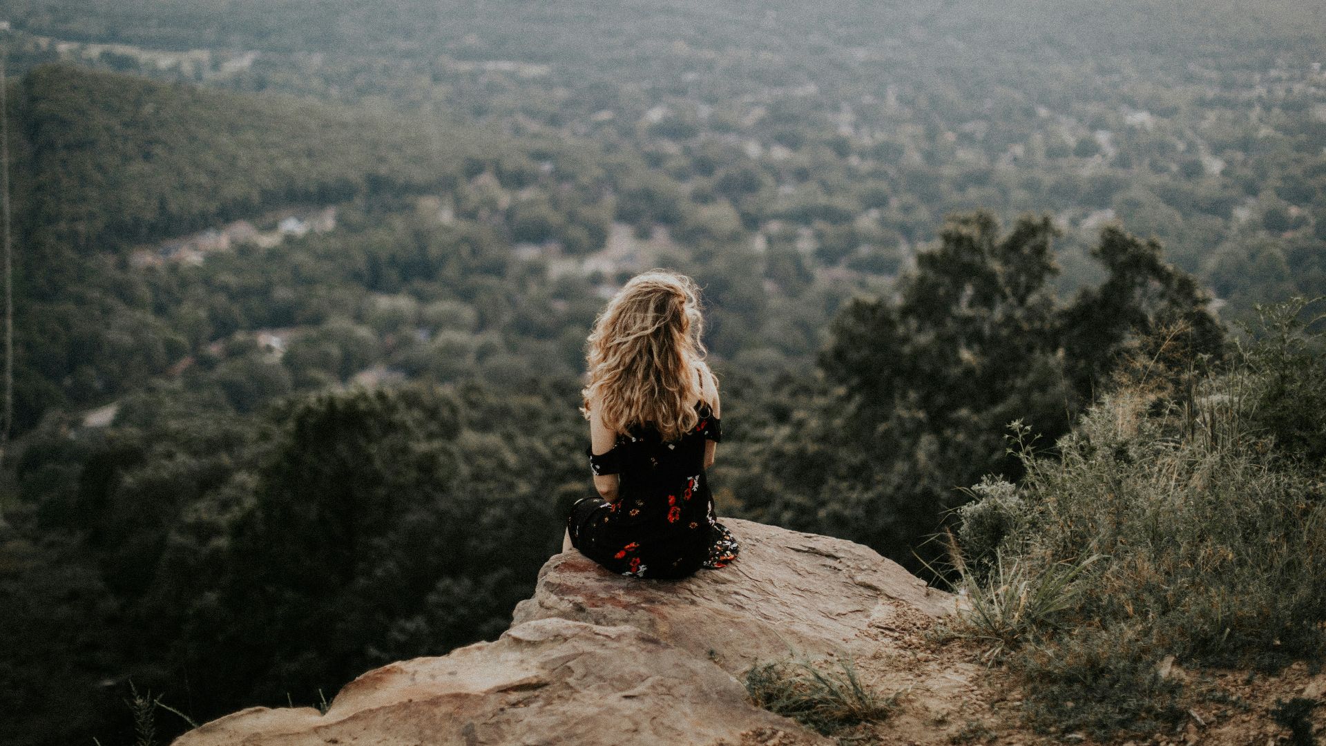 woman siting on cliff