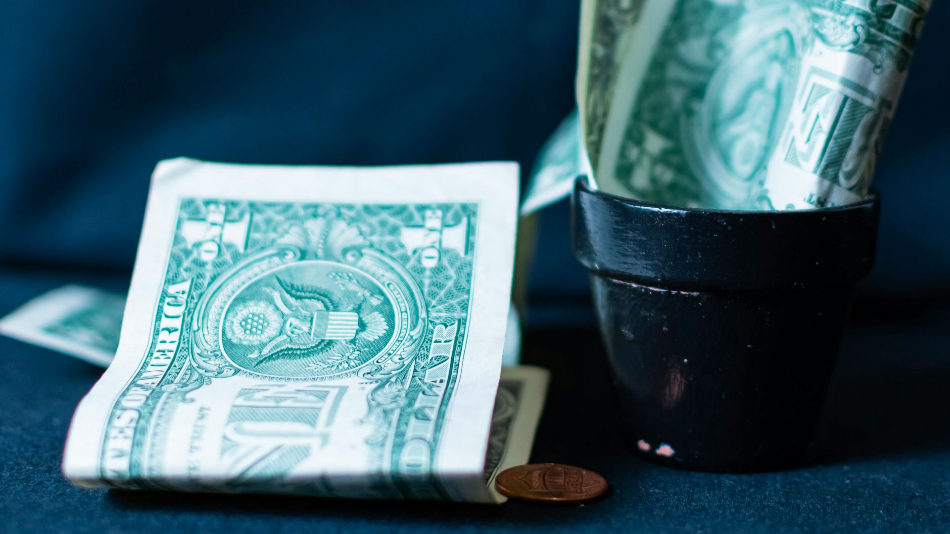 Us dollar bills in a small pot