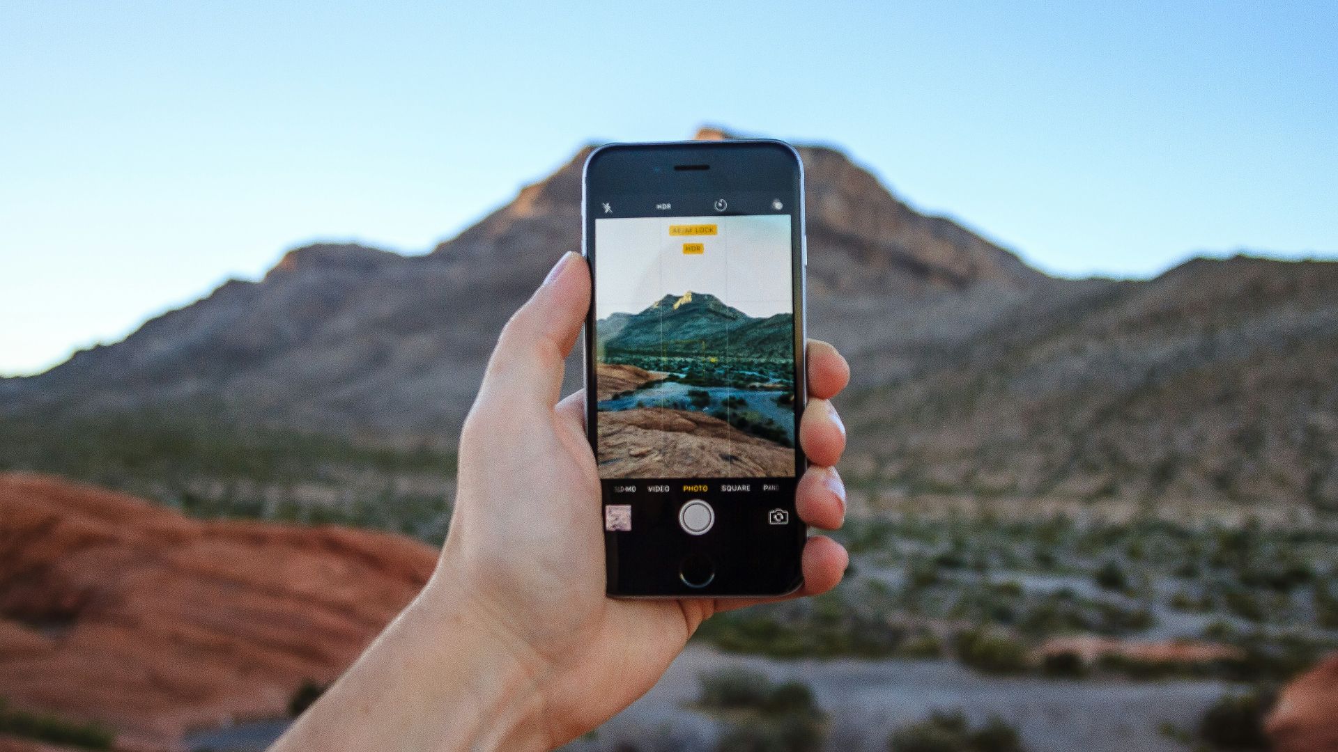 person taking a picture of mountain