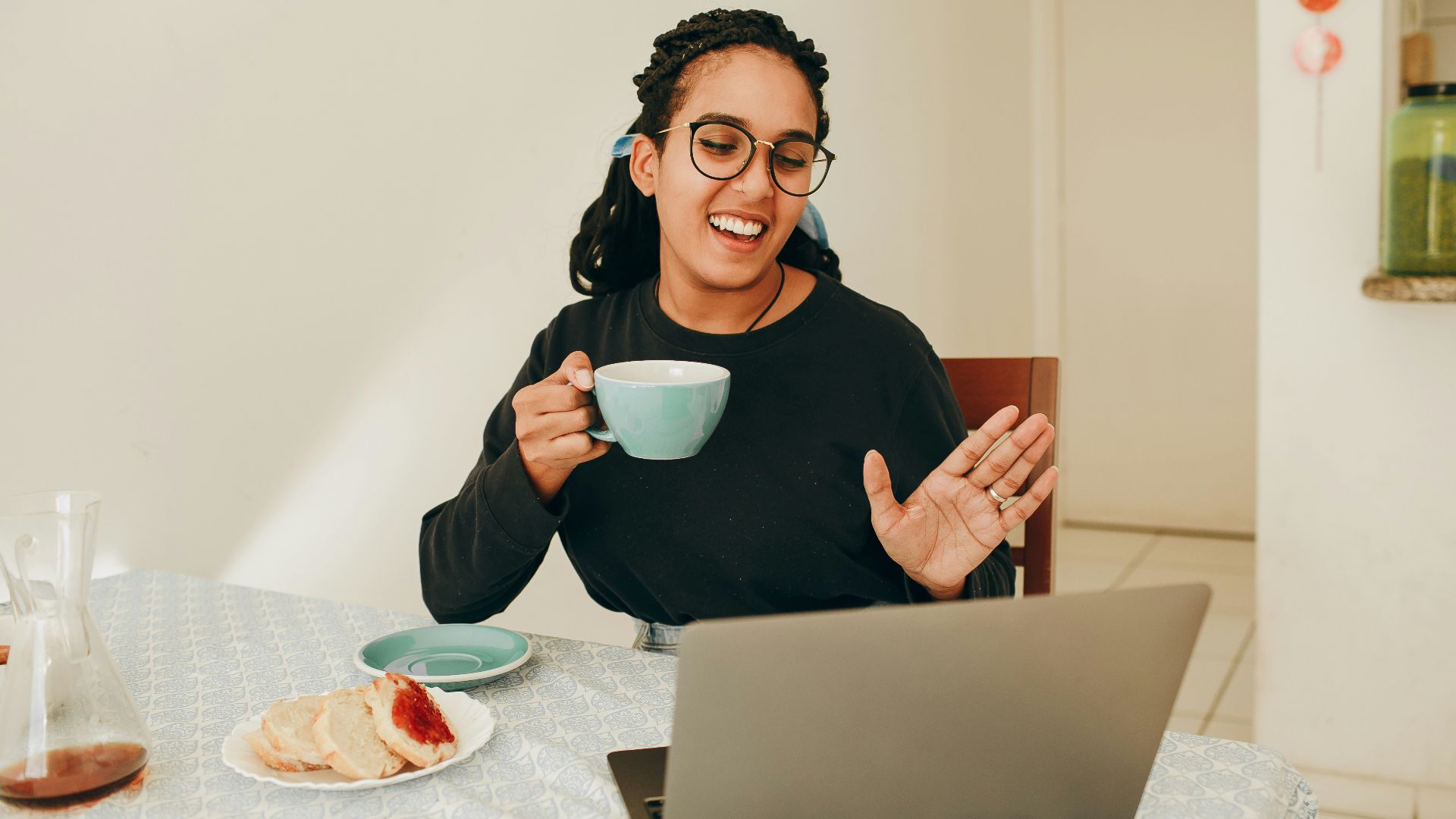 woman in black long sleeve shirt holding white ceramic mug
