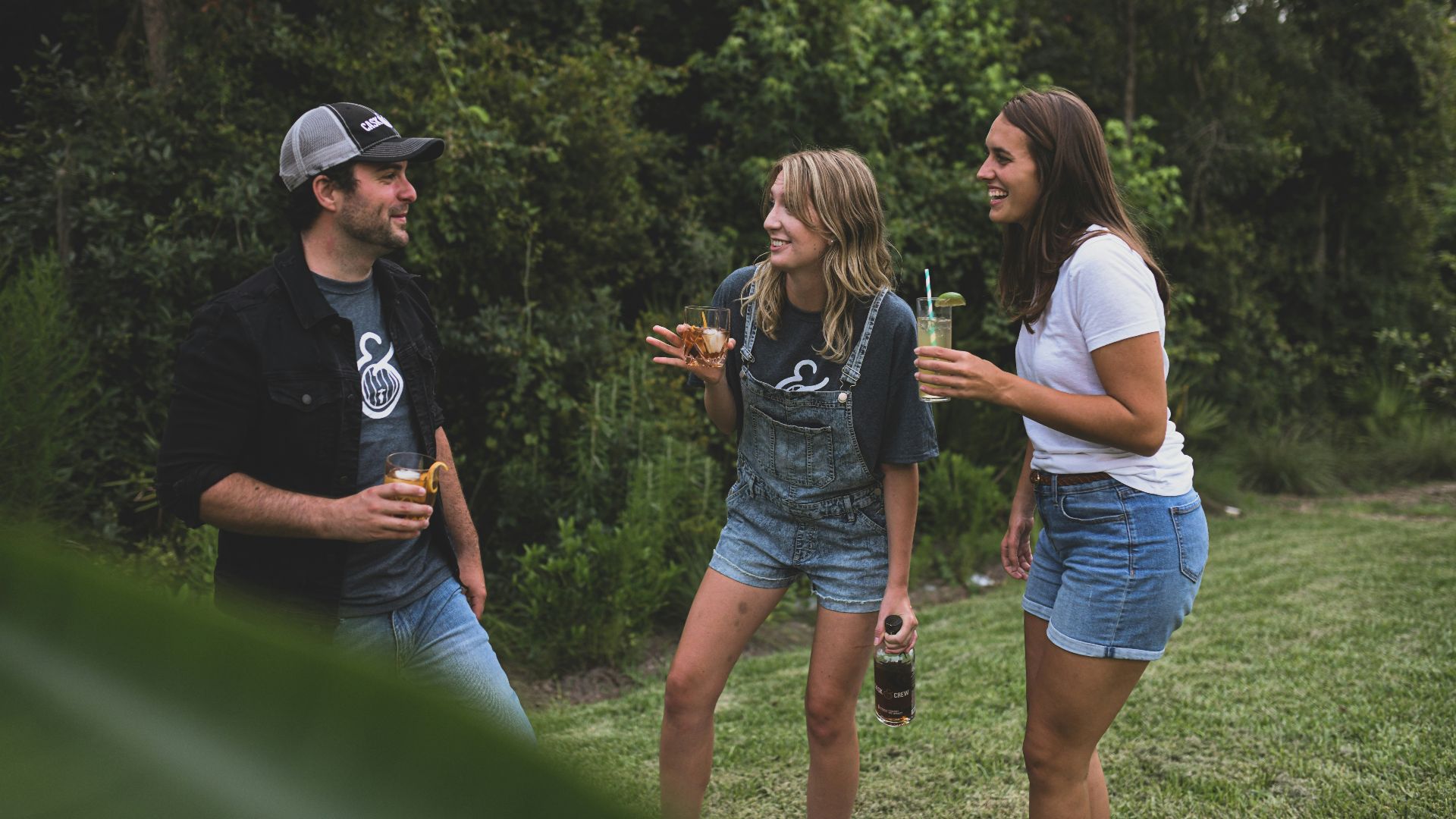 woman in black crew neck t-shirt and blue denim shorts standing beside woman in white