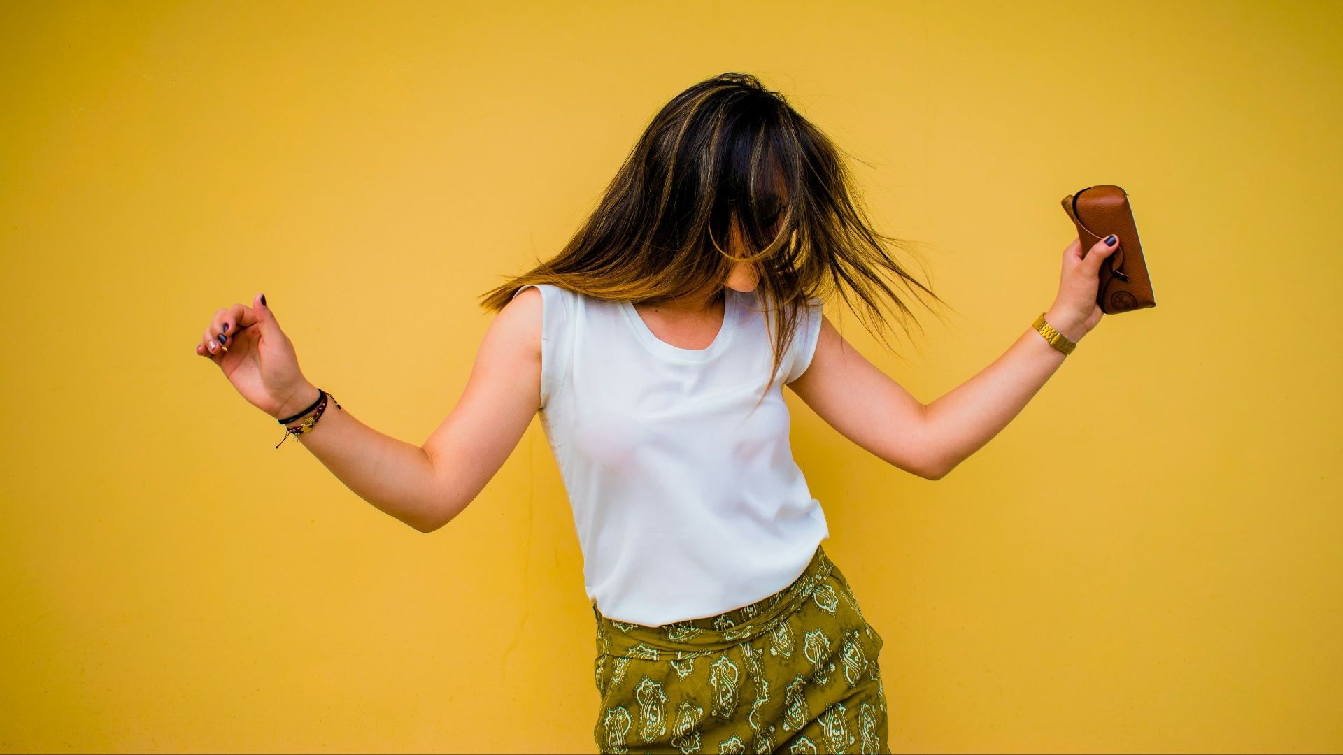 woman standing near yellow wall