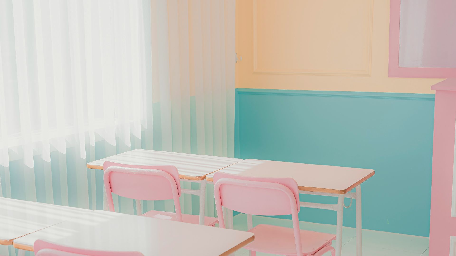 a room that has a bunch of pink chairs in it