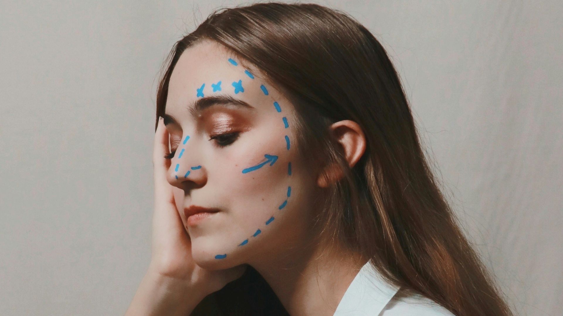 woman in white sleeveless shirt with blue eyes