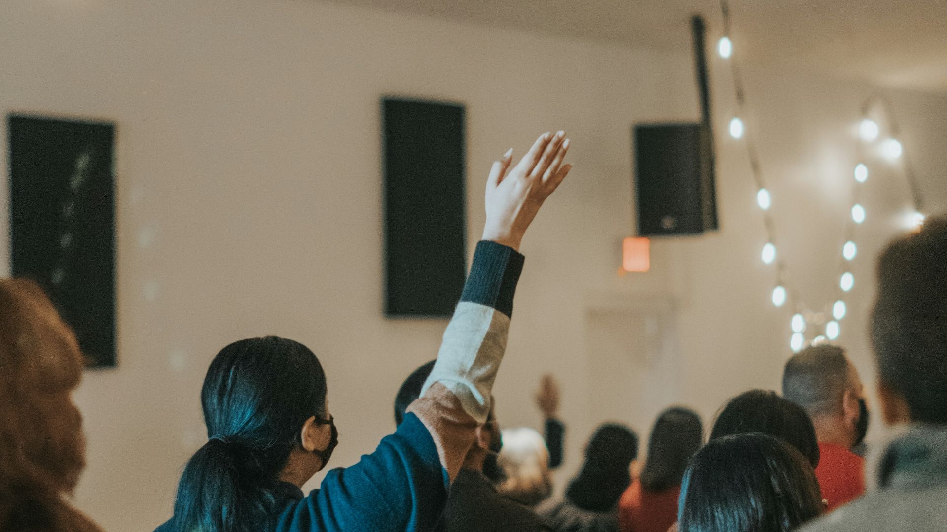 woman in blue long sleeve shirt holding black smartphone