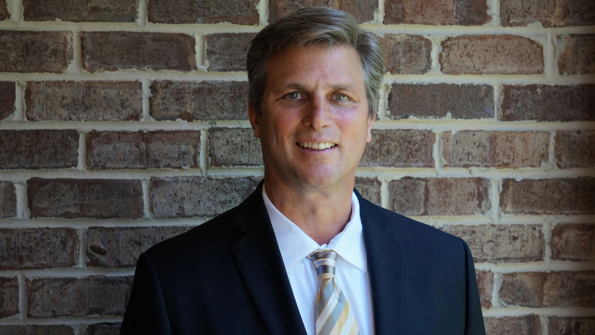 portrait photography of man wearing black suit jacket