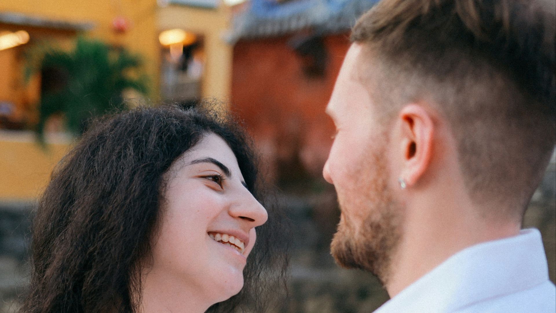 A couple embracing and smiling at each other