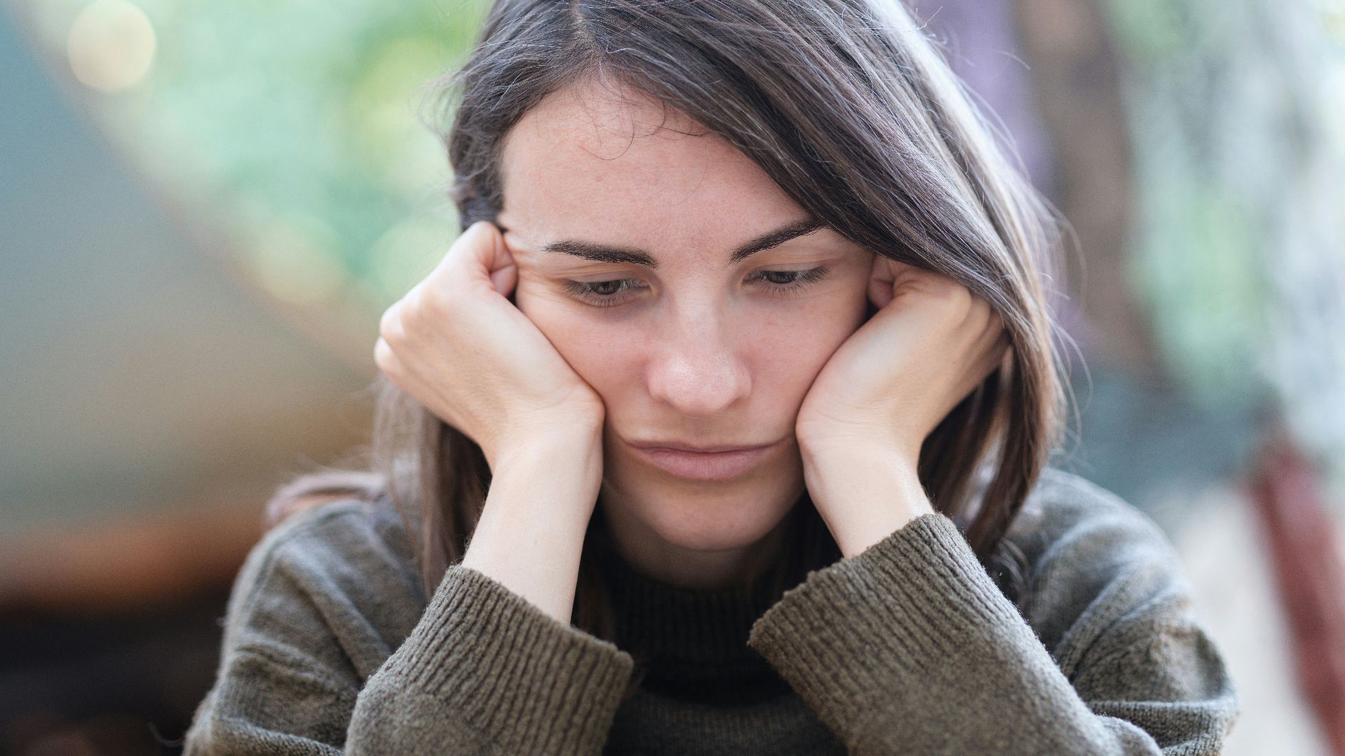 a woman holding her head in her hands