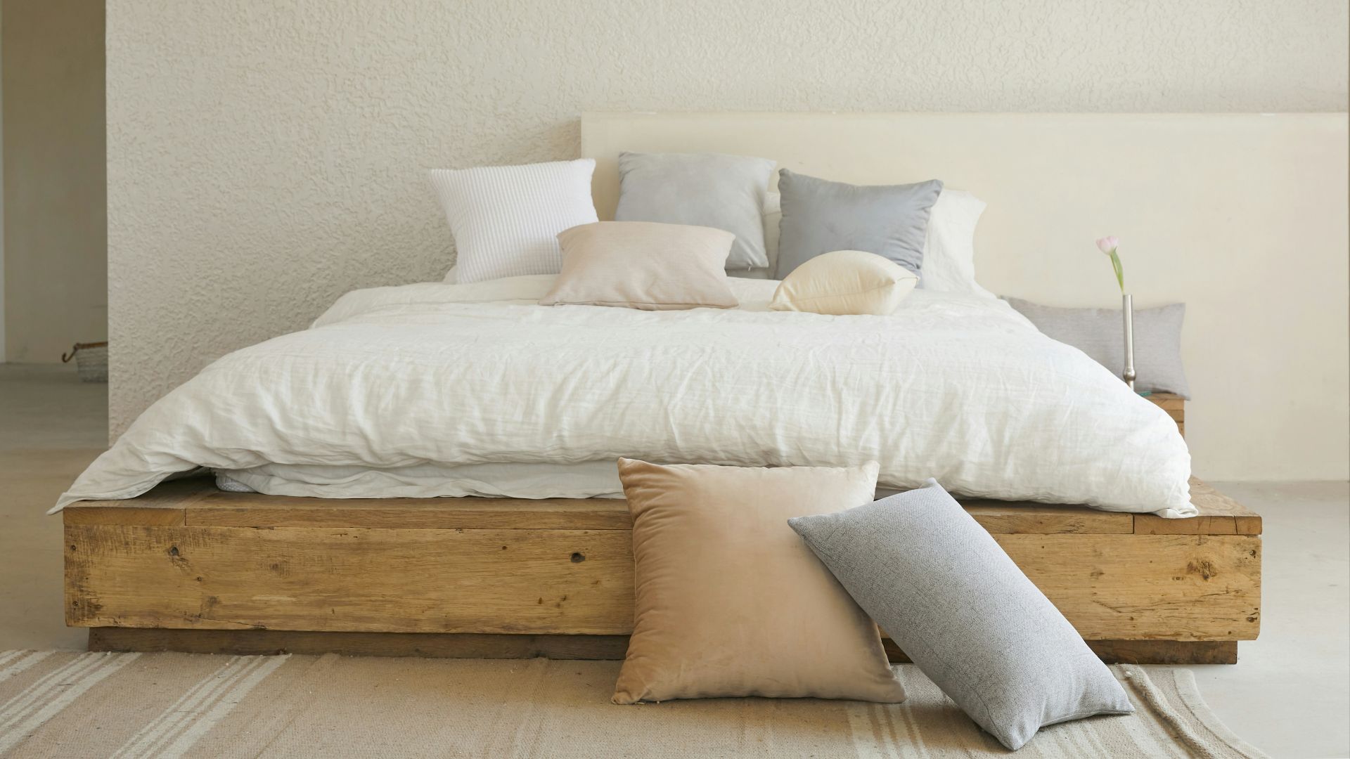 white bed pillow on brown wooden bed frame