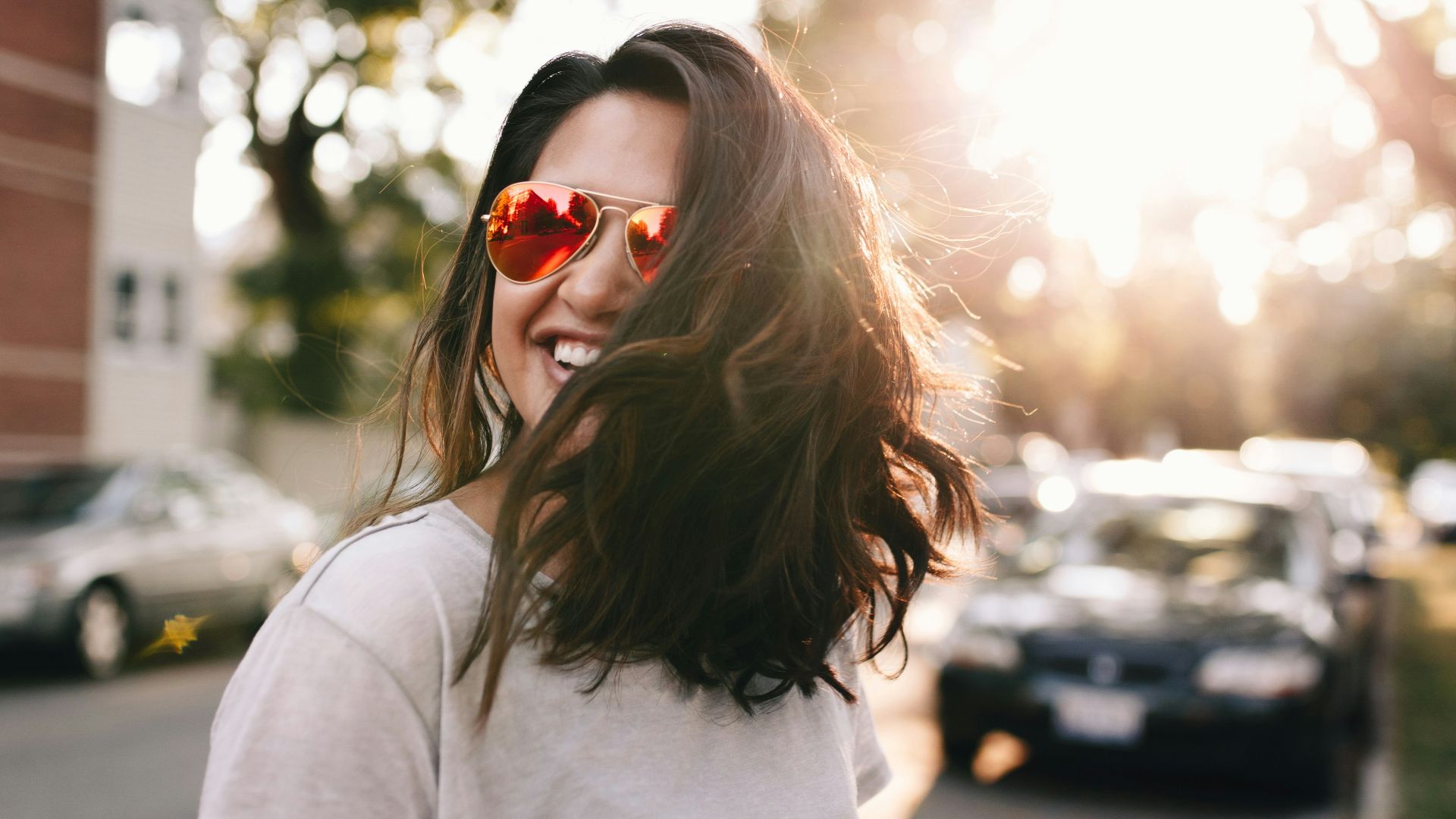woman wearing white T-shirt smiling