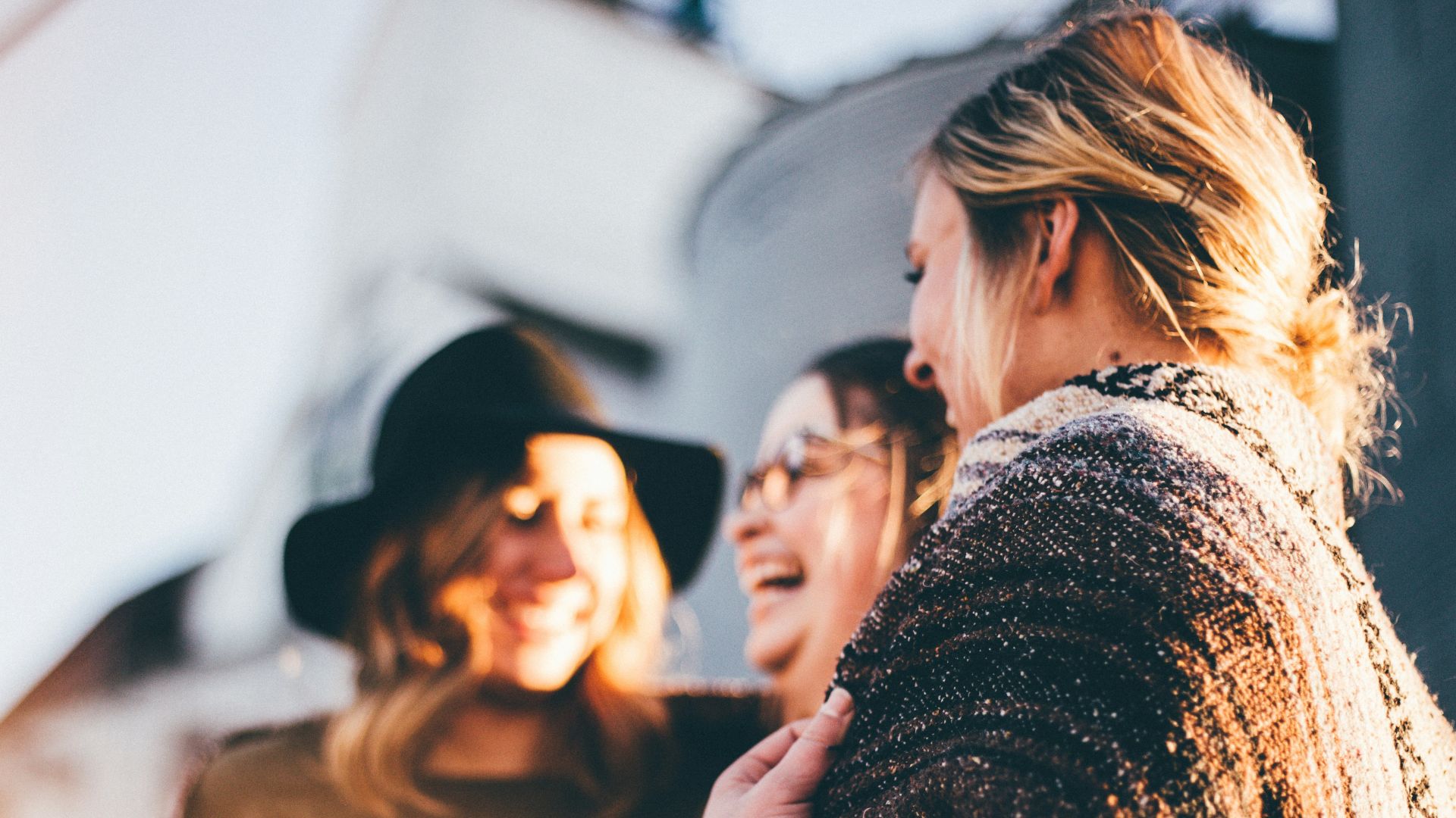 people laughing and talking outside during daytime