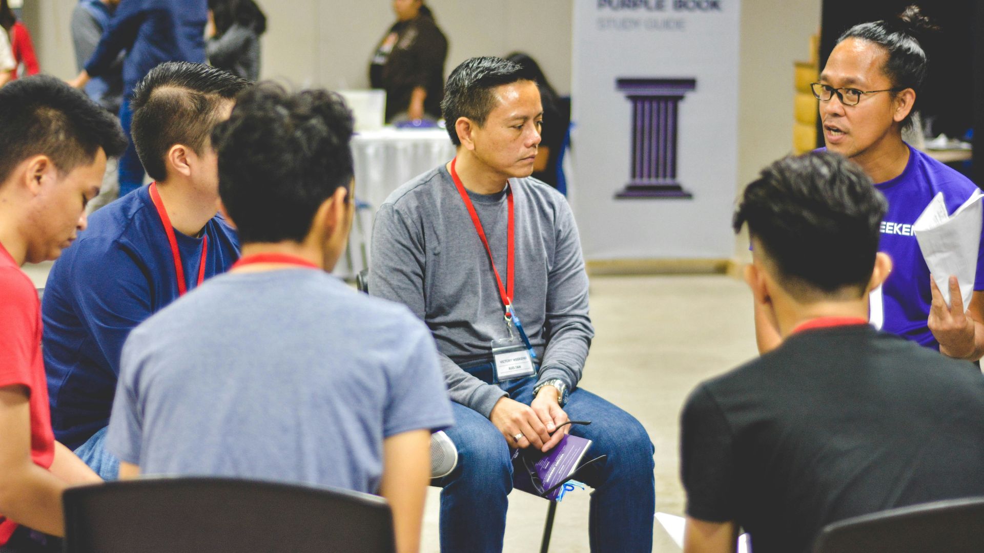 group of people having a conversation in a circle