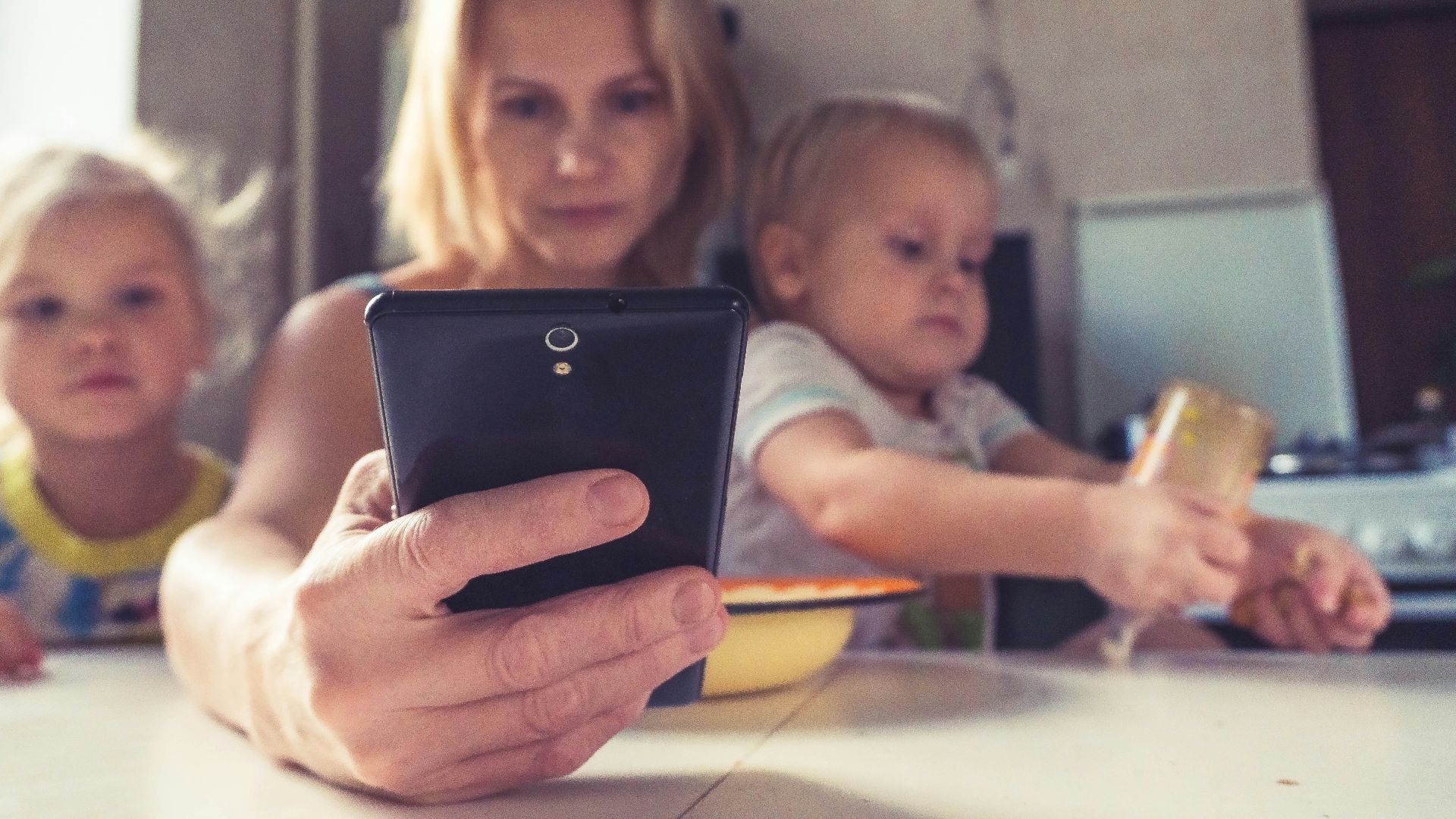 woman in white shirt holding black ipad