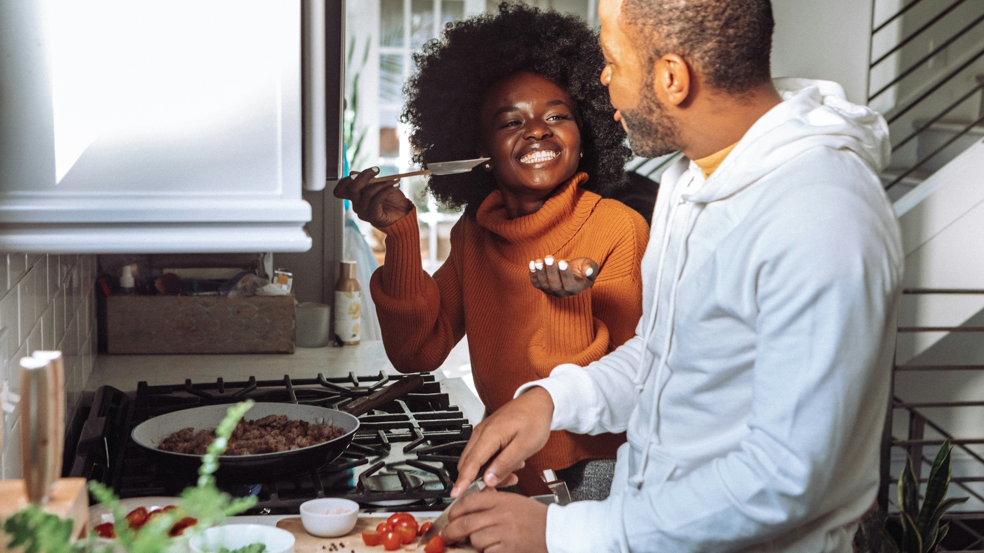 man in white dress shirt holding a woman in brown long sleeve shirt