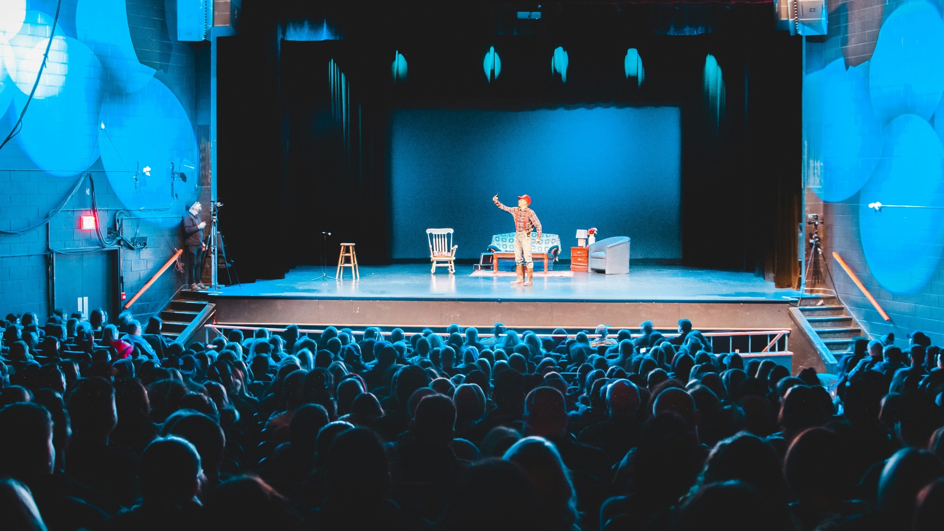 people standing on stage with lights turned on during nighttime