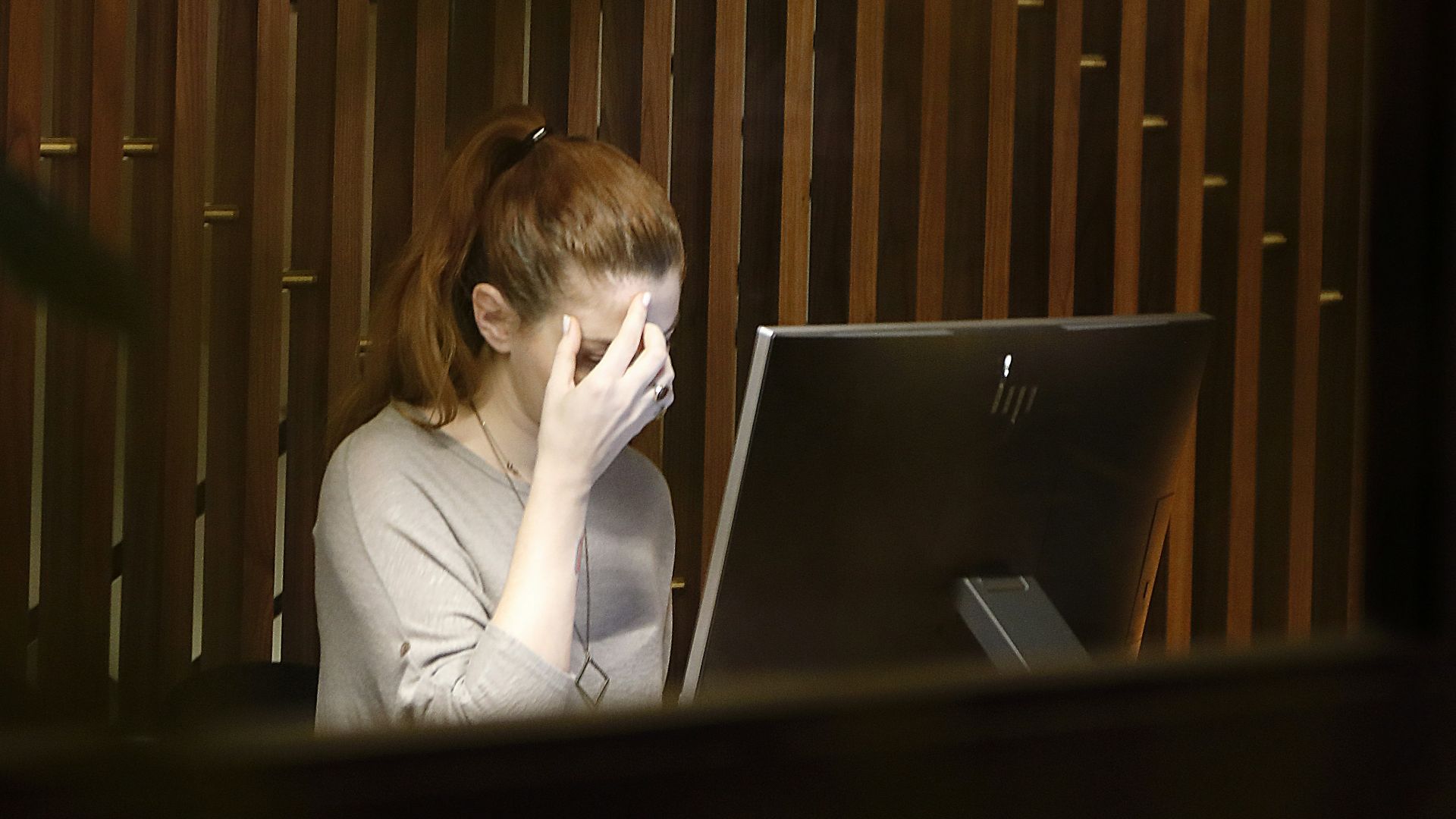 a woman sitting in front of a laptop computer