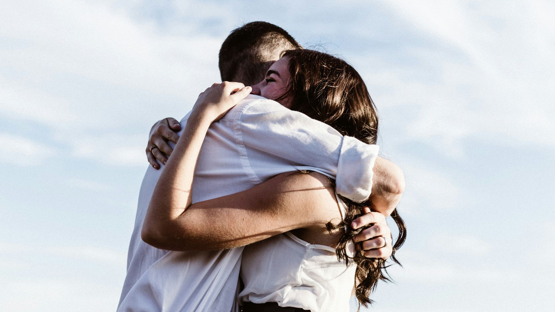 man and woman hugging each other photography
