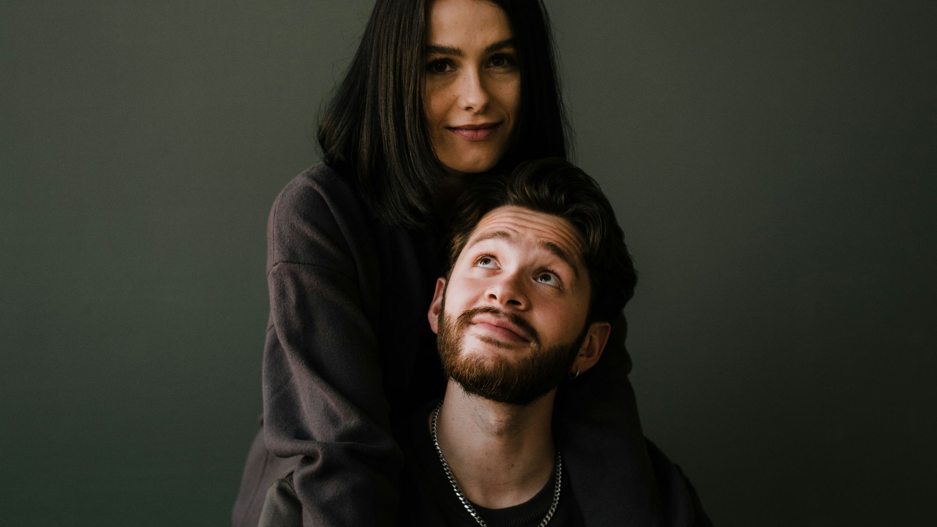 man in black crew neck shirt beside woman in black long sleeve shirt