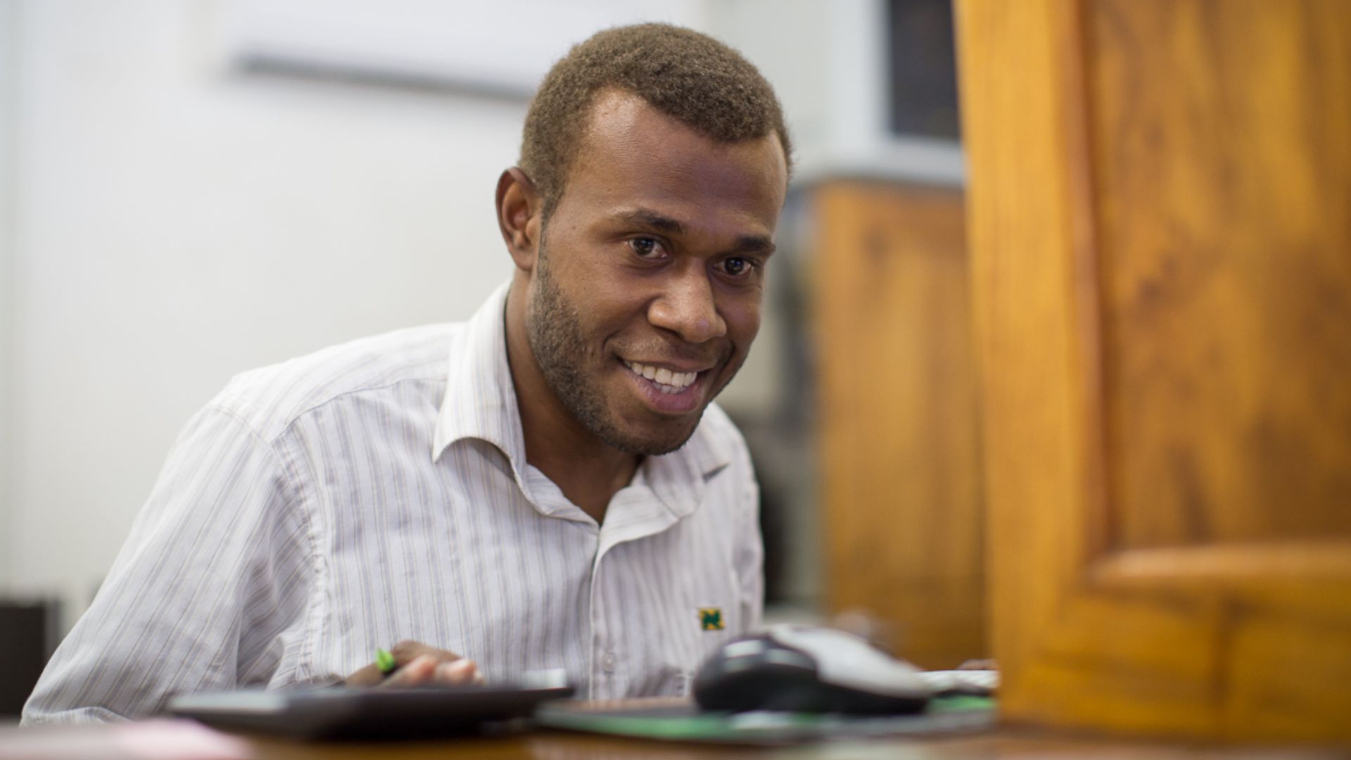 File:A bank teller serves a man at National Bank of Vanuatu on Malekula island. (10661217924).jpg
