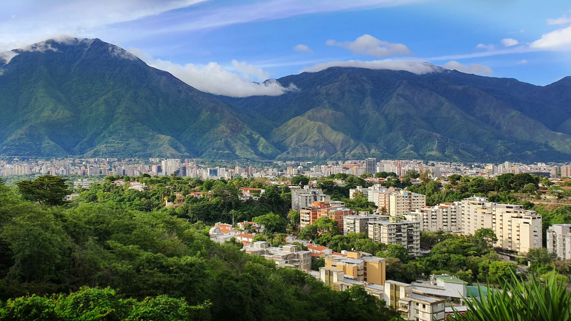 a view of a city with mountains in the background