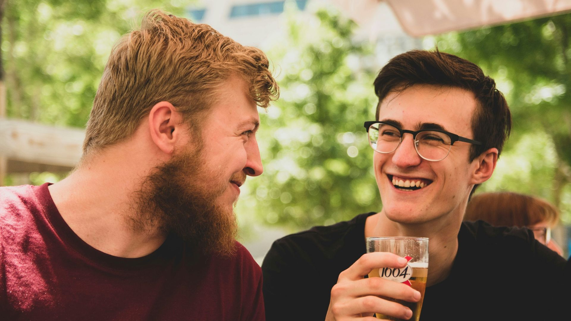 two men smiling near trees