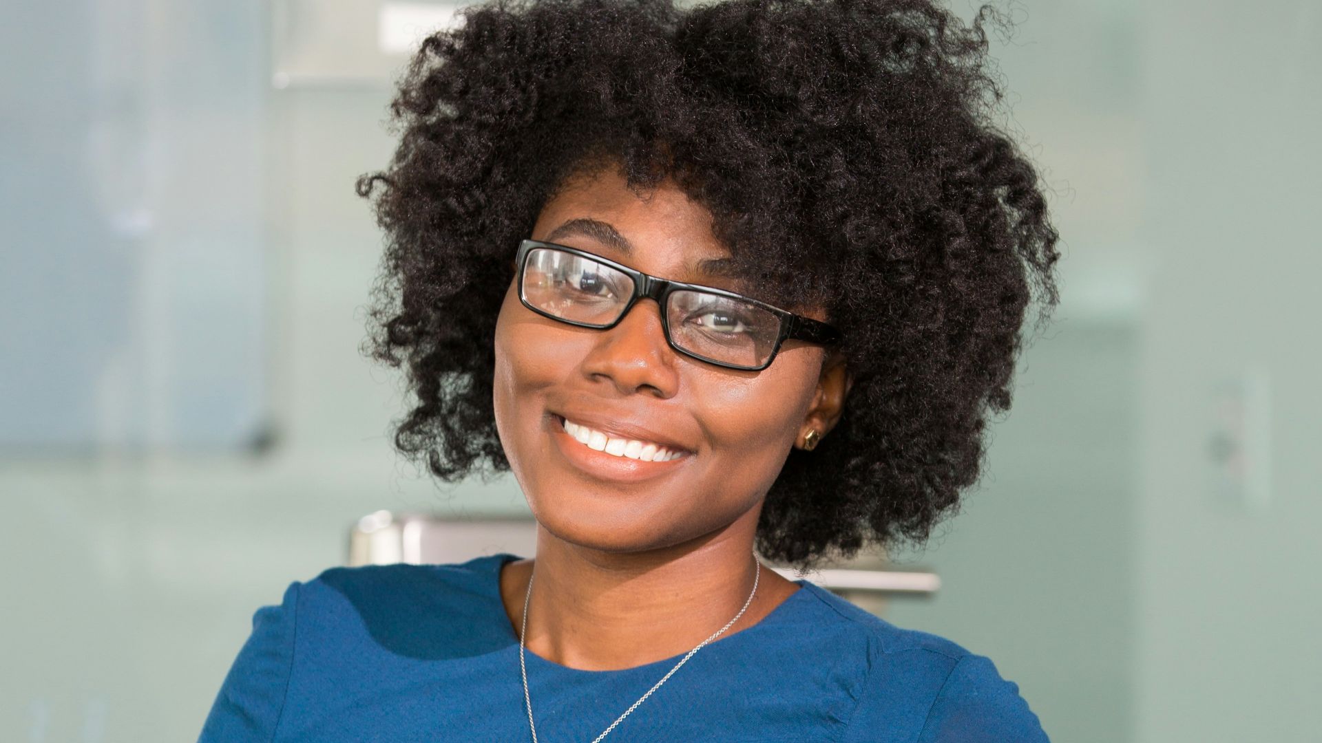 smiling woman sitting on black chair