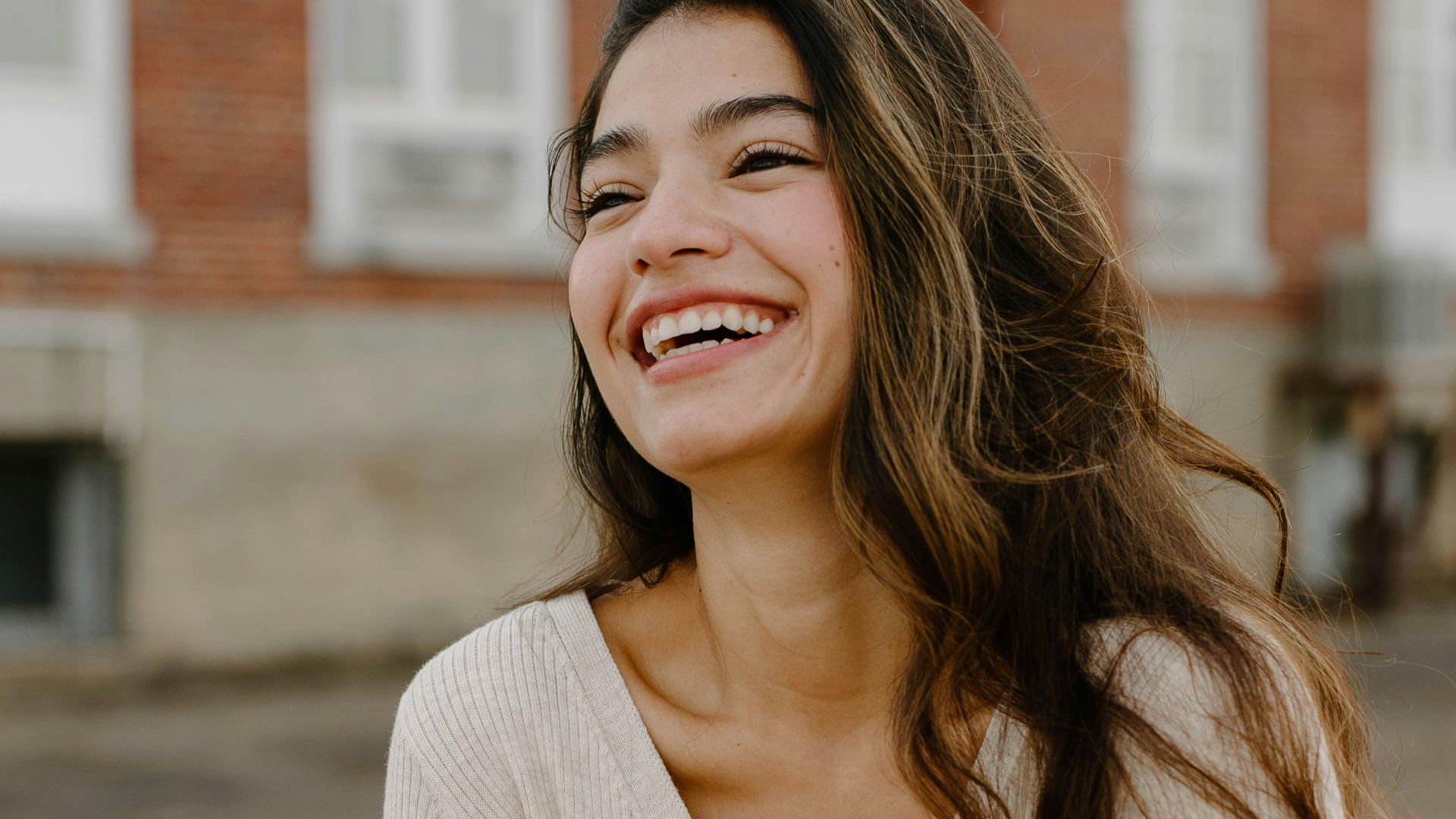 a woman smiling with her arms crossed