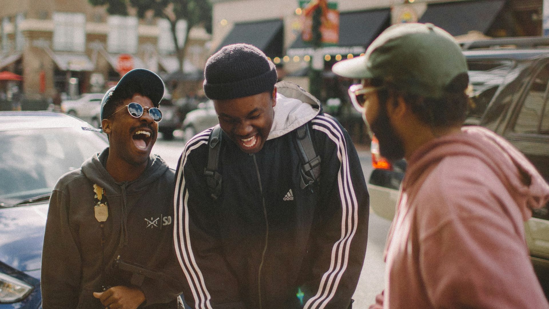 three men in jacket laughing at each other