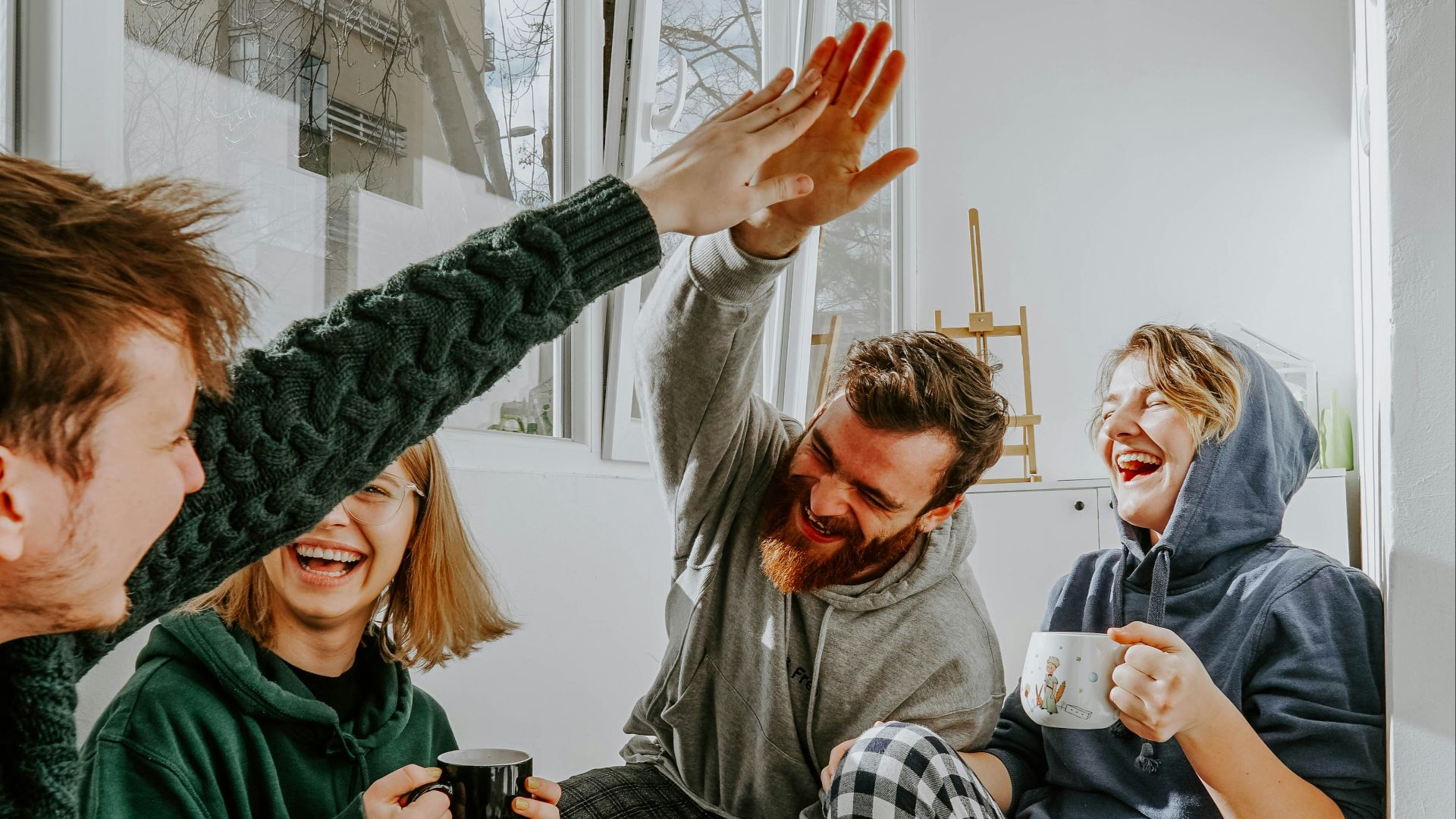woman in black and white checkered long sleeve shirt sitting beside man in green crew neck