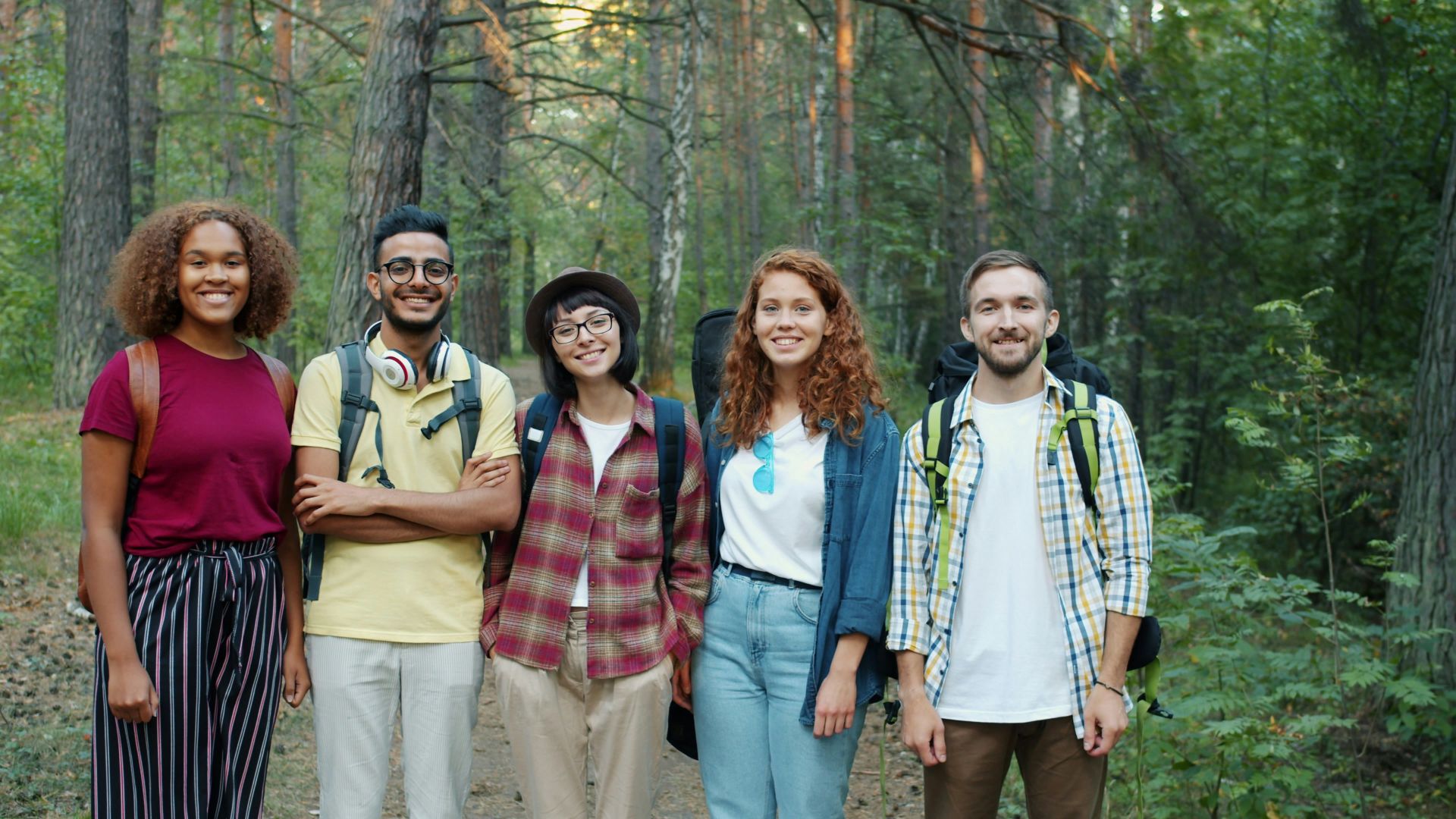 A diverse group of friends hiking in a forest
