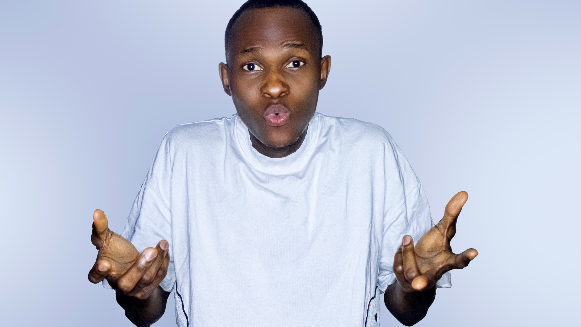 a young boy holding his hands up