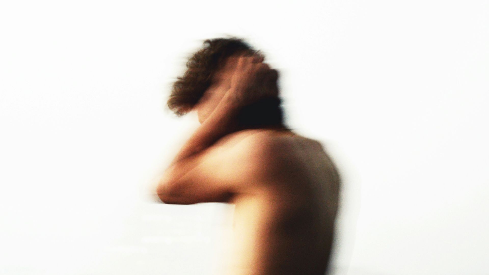 topless woman standing on beach during daytime