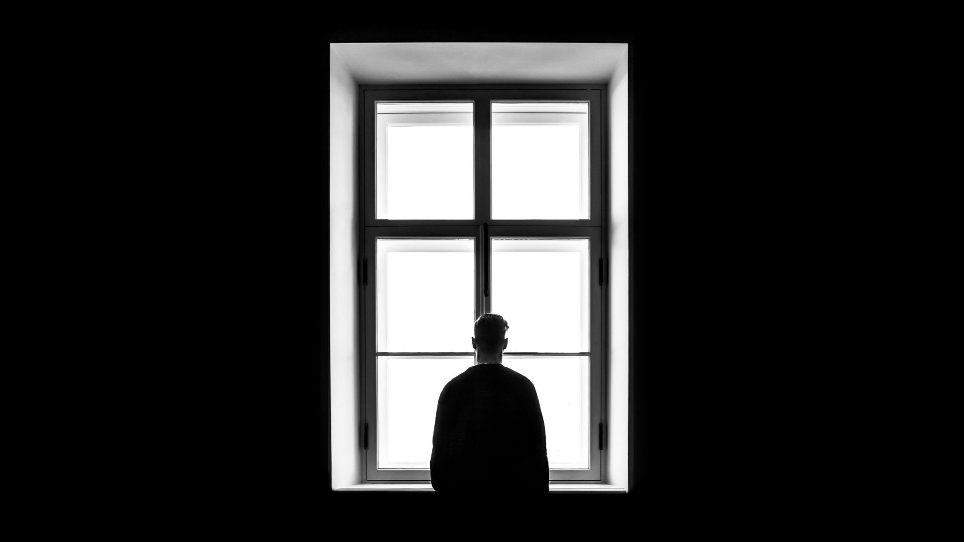 man standing in front of the window