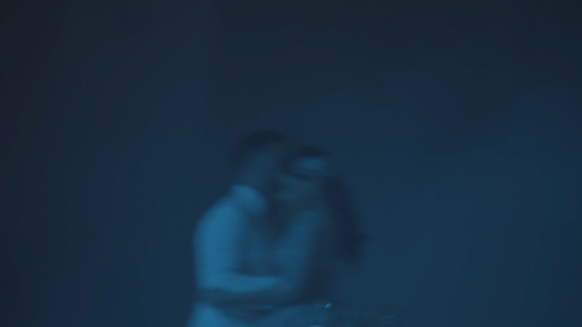 a blurry image of a woman holding a camera